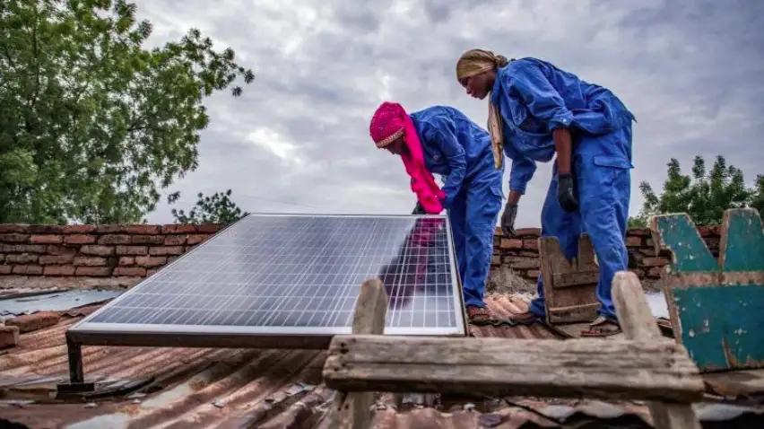 Two technicians installing a solar panel